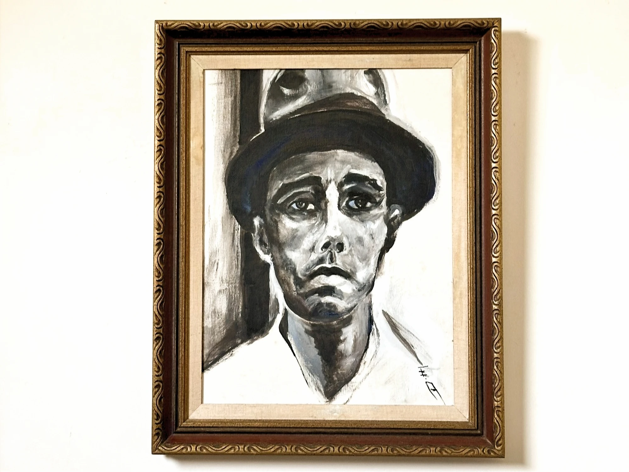 A stark monochrome portrait of a man in a dark brimmed hat, his lined face turned toward the viewer. Working Man, by Evelyn Altman.