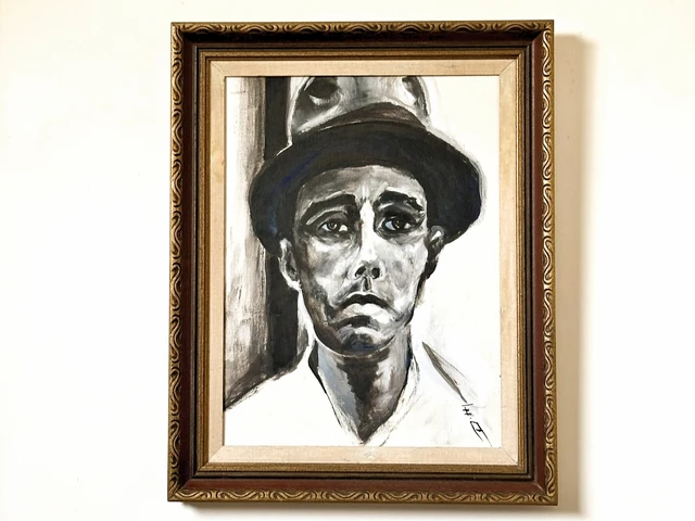 A stark monochrome portrait of a man in a dark brimmed hat, his lined face turned toward the viewer. Working Man, by Evelyn Altman.