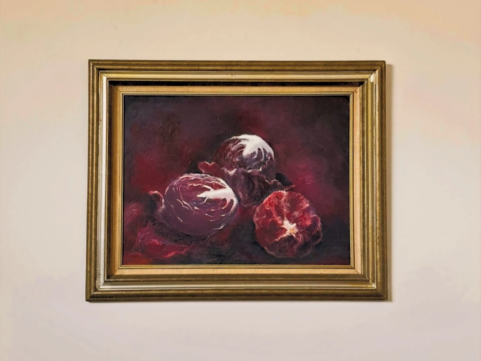 Three deep purple cabbages with pale curling leaves against a dark burgundy background. Cabbages, by Evelyn Altman.
