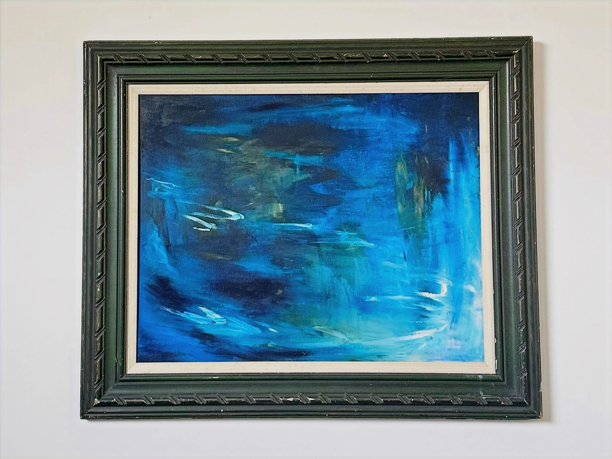 Swirling cobalt and turquoise water with light reflections and dark reeds at the edge of a lagoon. Blue Lagoon, by Evelyn Altman.