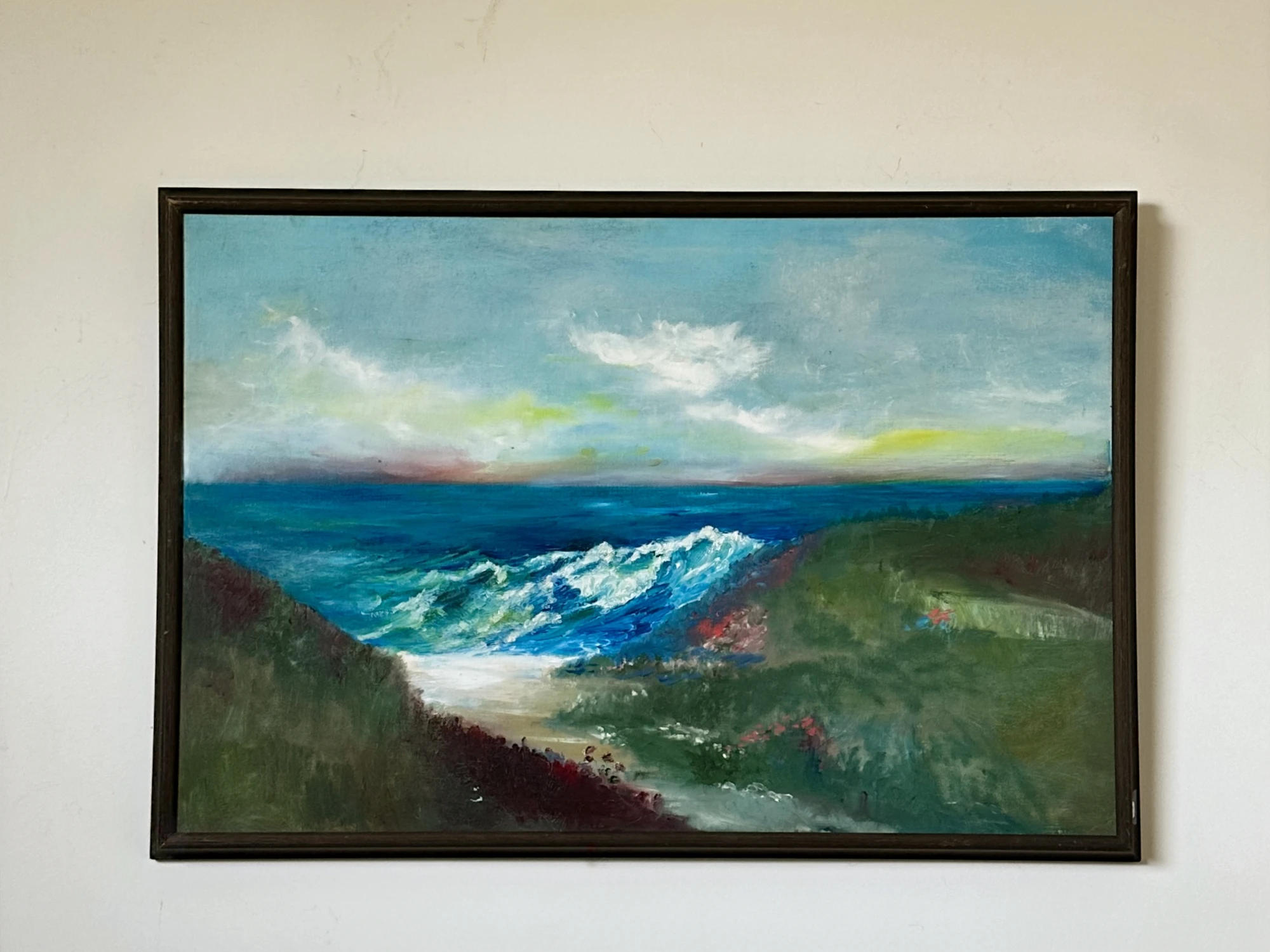 White surf washing into a green coastal inlet beneath layered clouds at Half Moon Bay. A Scene in Half Moon Bay, by Evelyn Altman.