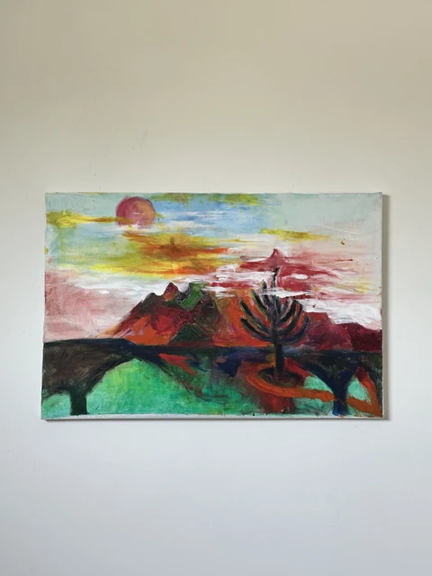 A dark branching tree before red and green hills, beneath a pink and yellow sky with a muted red sun. Sky + Tree, by Evelyn Altman.