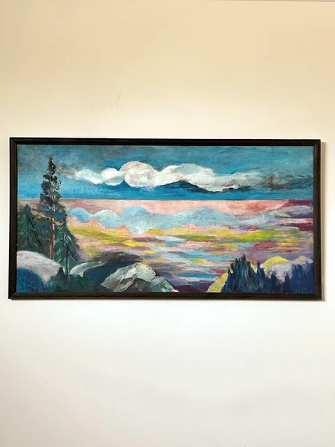 A long mountain panorama with an evergreen tree, pale rocks and layered bands of sunset clouds. Panoramic Dreams, by Evelyn Altman.