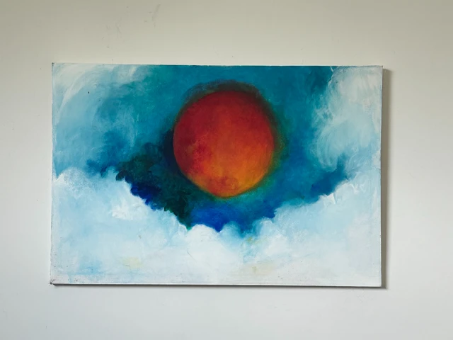 A large red-orange sun glowing in a deep turquoise sky bordered by soft white clouds. Glory to The Sun, by Evelyn Altman.