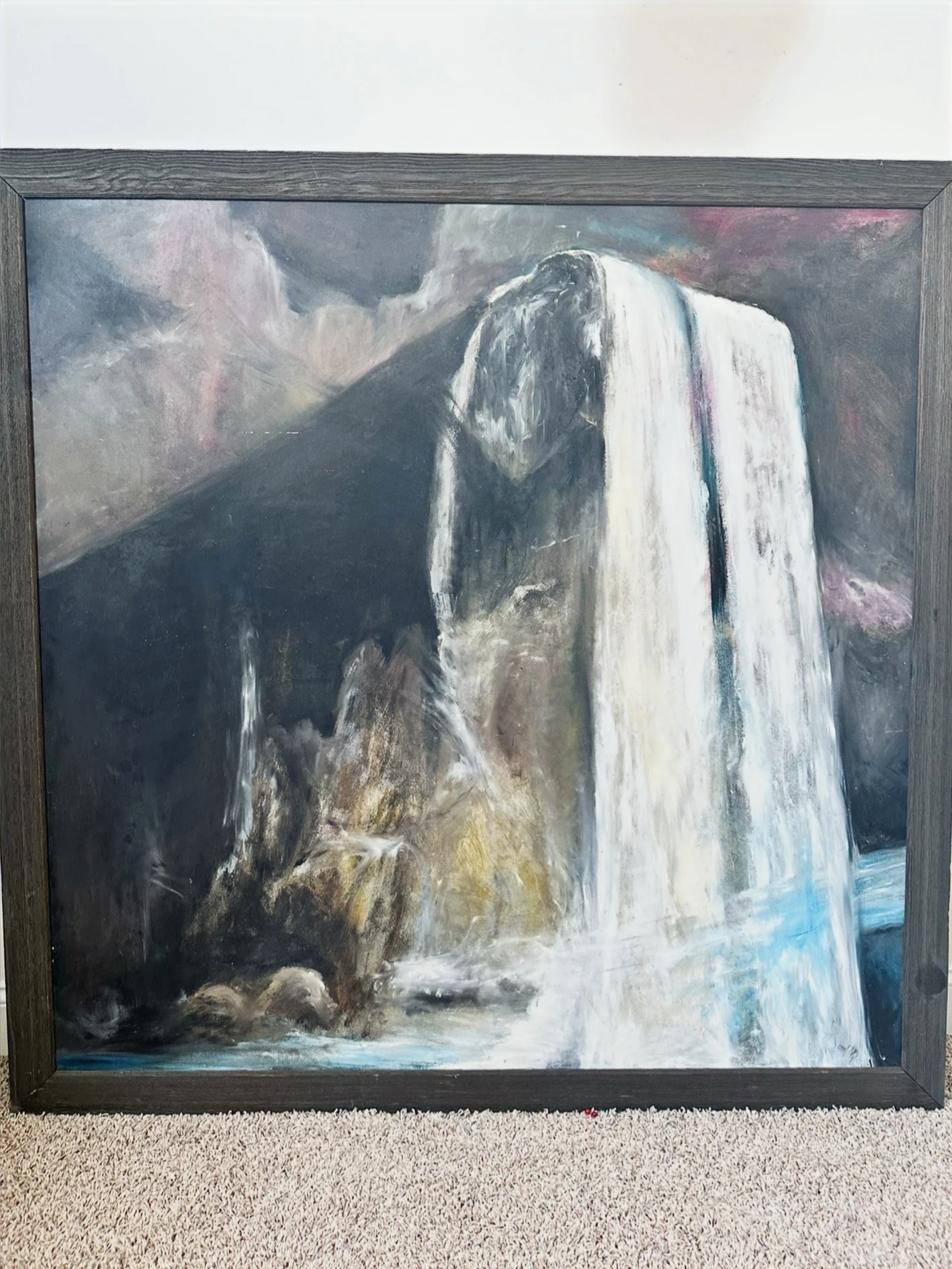 A broad white waterfall pouring down a dark mountain cliff under a misty sky. Water Falls, by Evelyn Altman.