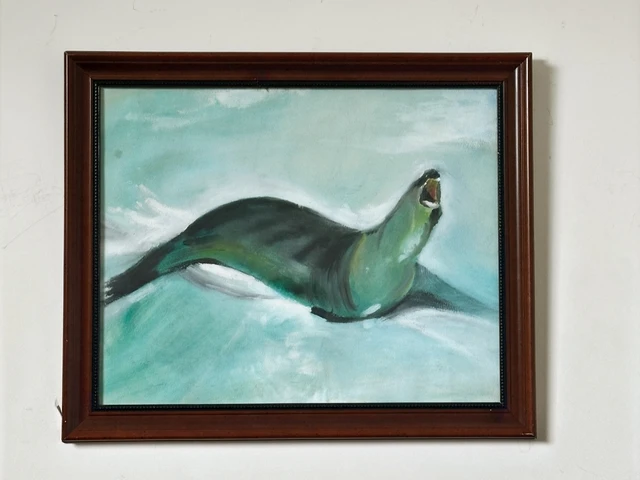 A dark seal gliding through pale green water with its head raised. Seal, by Evelyn Altman.
