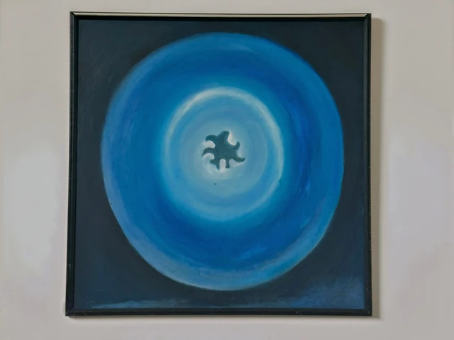Concentric blue rings surrounding a small dark shape on a pale blue center. Symbol of Nothingness, by Evelyn Altman.