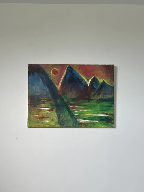 Blue mountain peaks and green reflections beneath a small yellow-red sun and a rust-colored sky. Mountains of Lake Tahoe California, by Evelyn Altman.