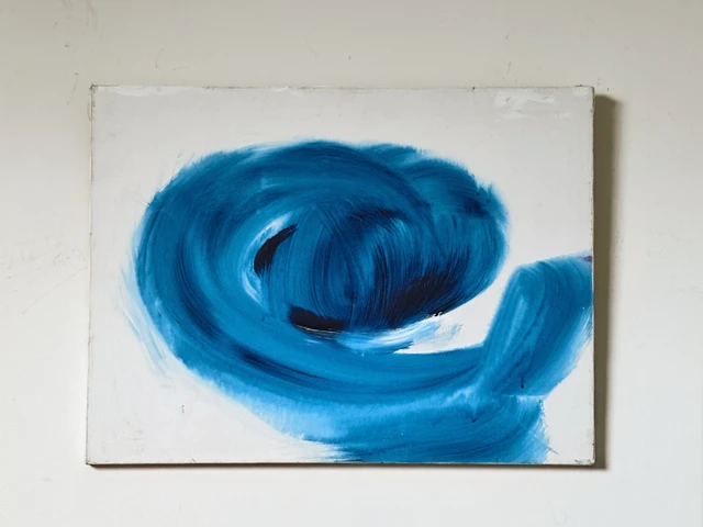 A bold curling wave of deep blue paint against a pale background. Blue Mood, by Evelyn Altman.