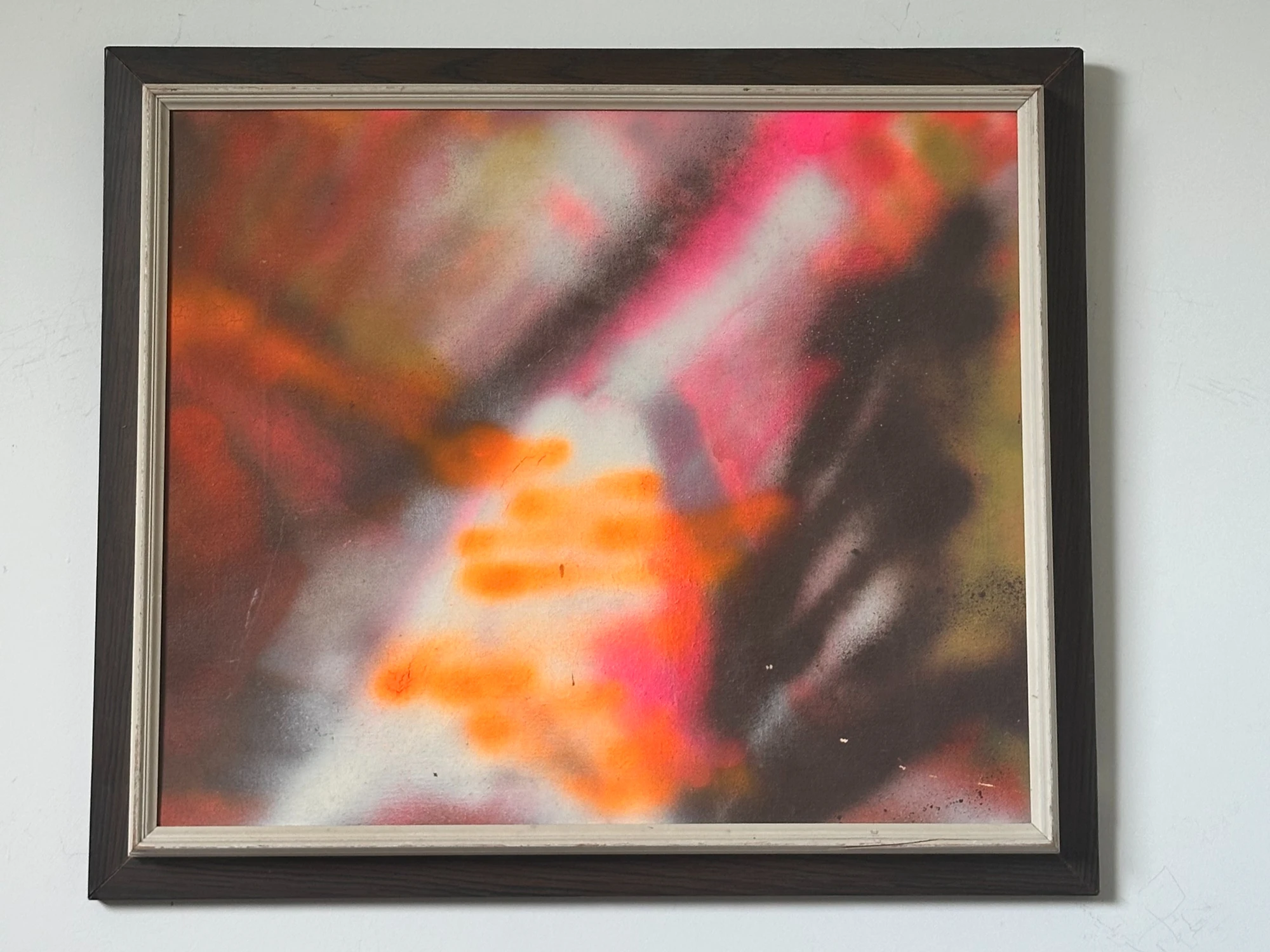 Blurred red, orange and cream forms surrounded by dark gray and black. Abstract, by Evelyn Altman.
