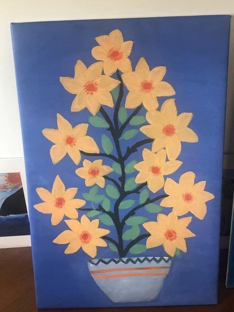 Pale yellow flowers with orange centers and dark green stems in a striped blue vase against a deep blue background. Blue Flowers, by Laida Altman.