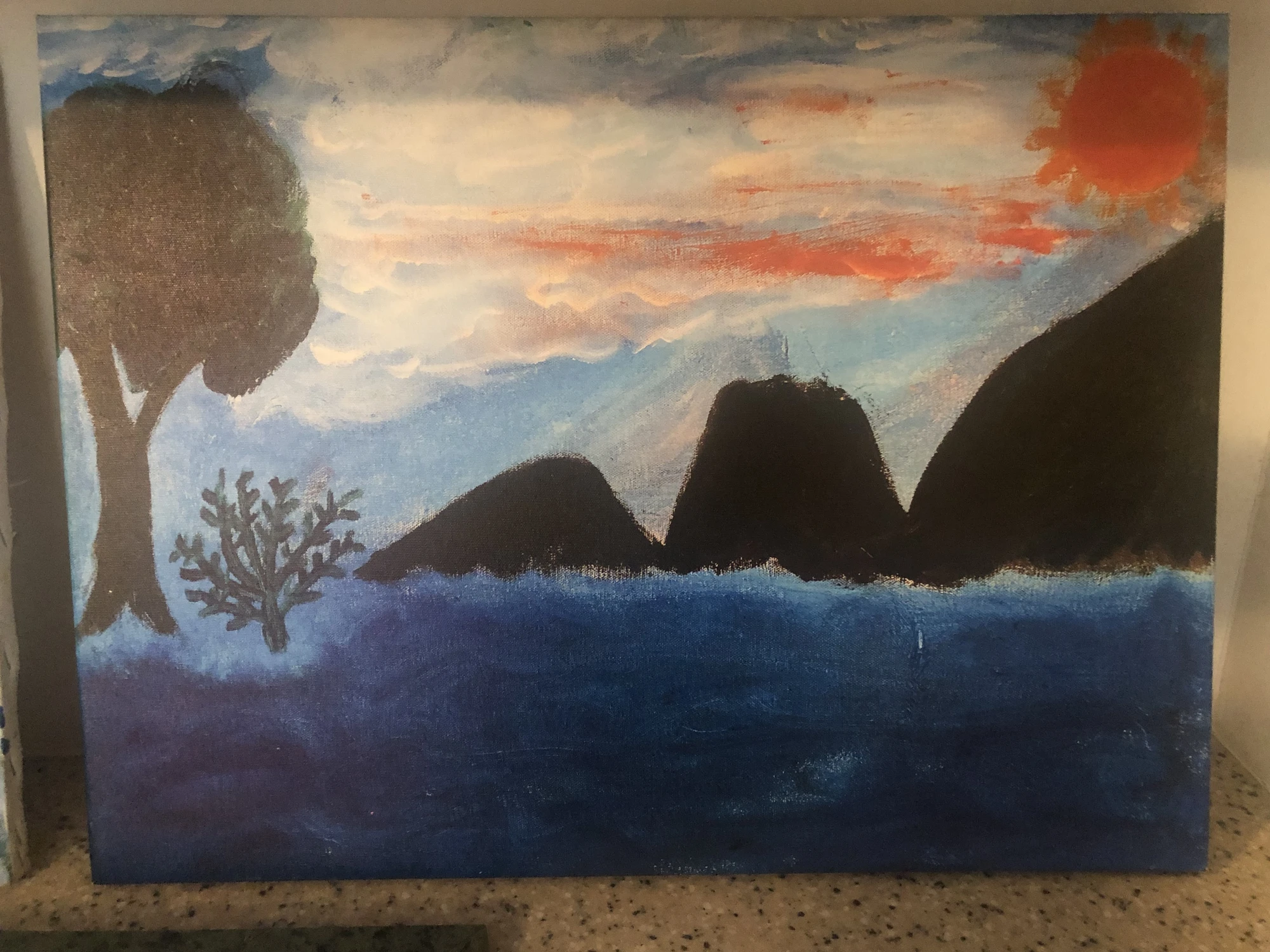 Dark mountain silhouettes and branching forms beneath a streaked orange-gray sky over blue water. In The Beginning, by Laida Altman.